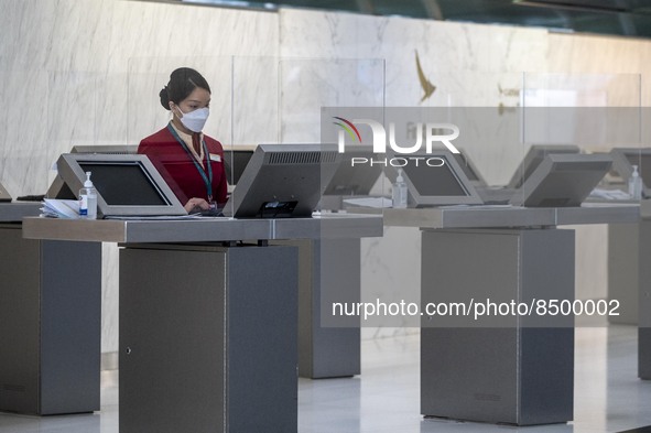 A Cathay Pacific Workers standing at a booth inside Hong Kong International Airport on July 7, 2022 in Hong Kong, China. The Hong Kong Gover...