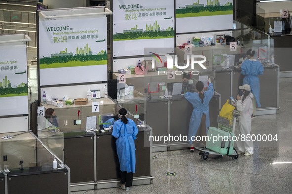 Travellers sanding at a booth inside Hong Kong International Airport on July 7, 2022 in Hong Kong, China. The Hong Kong Government announce...