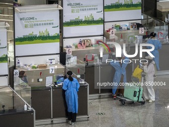 Travellers sanding at a booth inside Hong Kong International Airport on July 7, 2022 in Hong Kong, China. The Hong Kong Government announce...