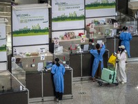 Travellers sanding at a booth inside Hong Kong International Airport on July 7, 2022 in Hong Kong, China. The Hong Kong Government announce...