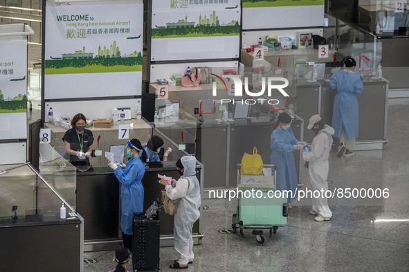 Travellers sanding at a booth inside Hong Kong International Airport on July 7, 2022 in Hong Kong, China. The Hong Kong Government announce...