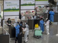 Travellers sanding at a booth inside Hong Kong International Airport on July 7, 2022 in Hong Kong, China. The Hong Kong Government announce...