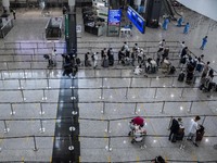 Travellers waiting in line for shuttle bus to quarantine hotels inside Hong Kong International Airport on July 7, 2022 in Hong Kong, China....