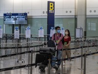 Travellers pushing luggage trolley after arrive in Hong Kong inside Hong Kong International Airport on July 7, 2022 in Hong Kong, China. The...