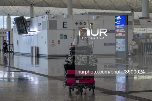 A Man pushing a luggage trolley inside Hong Kong International Airport on July 7, 2022 in Hong Kong, China. The Hong Kong Government announc...