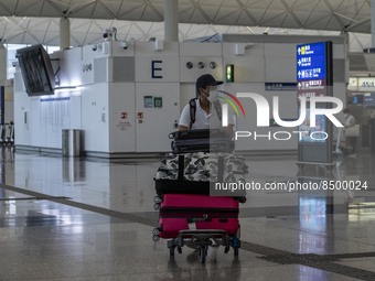 A Man pushing a luggage trolley inside Hong Kong International Airport on July 7, 2022 in Hong Kong, China. The Hong Kong Government announc...