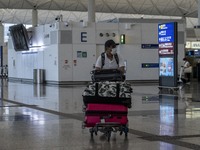 A Man pushing a luggage trolley inside Hong Kong International Airport on July 7, 2022 in Hong Kong, China. The Hong Kong Government announc...