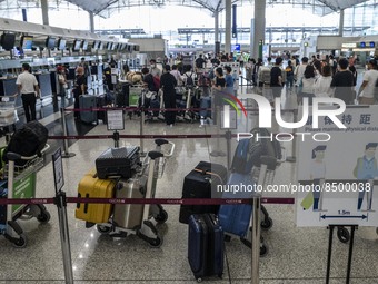 Luggage lining up at a check in counter inside Hong Kong International Airport on July 7, 2022 in Hong Kong, China. The Hong Kong Government...