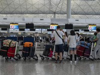 Travellers lining up at a check in counter inside Hong Kong International Airport on July 7, 2022 in Hong Kong, China. The Hong Kong Governm...