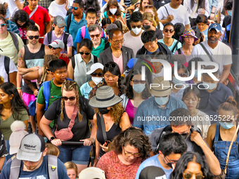 People crowd onto a ferry boat going from Toronto to Centre Island at the ferry terminal in Toronto, Ontario, Canada on July 08, 2022. Heath...