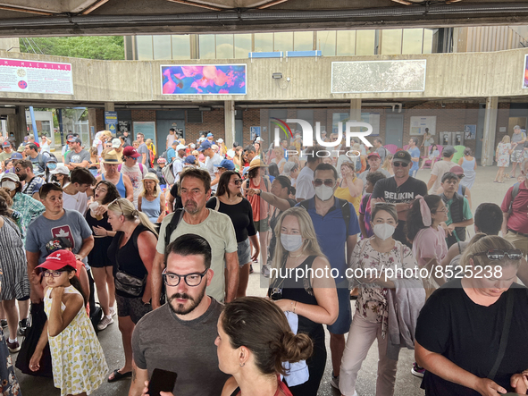 Crowd of people wait to board a ferry boat going from Toronto to Centre Island at the ferry terminal in Toronto, Ontario, Canada on July 08,...