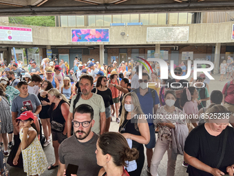 Crowd of people wait to board a ferry boat going from Toronto to Centre Island at the ferry terminal in Toronto, Ontario, Canada on July 08,...