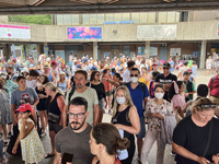 Crowd of people wait to board a ferry boat going from Toronto to Centre Island at the ferry terminal in Toronto, Ontario, Canada on July 08,...