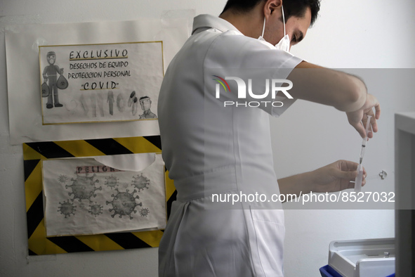  A health worker prepares a Pfizer's Covid19 dose during a mass vaccination campaign for  children under 9 years of age  to prevent infectio...