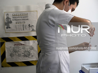  A health worker prepares a Pfizer's Covid19 dose during a mass vaccination campaign for  children under 9 years of age  to prevent infectio...