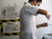  A health worker prepares a Pfizer's Covid19 dose during a mass vaccination campaign for  children under 9 years of age  to prevent infectio...