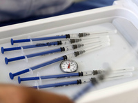  A health worker prepares a Pfizer's Covid19 dose during a mass vaccination campaign for  children under 9 years of age  to prevent infectio...