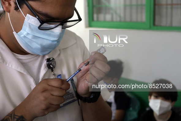  A health worker prepares a Pfizer's Covid19 dose during a mass vaccination campaign for  children under 9 years of age  to prevent infectio...