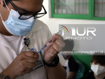  A health worker prepares a Pfizer's Covid19 dose during a mass vaccination campaign for  children under 9 years of age  to prevent infectio...