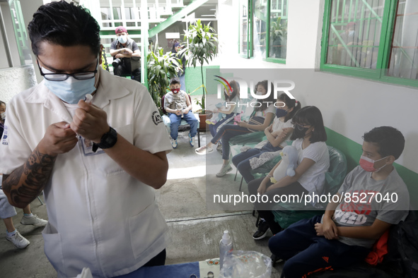  A health worker prepares a Pfizer's Covid19 dose during a mass vaccination campaign for  children under 9 years of age  to prevent infectio...