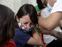  A child receives a Pfizer first dose at the  Portales Health Center during a health campaign to children under 9 years of age  at the start...