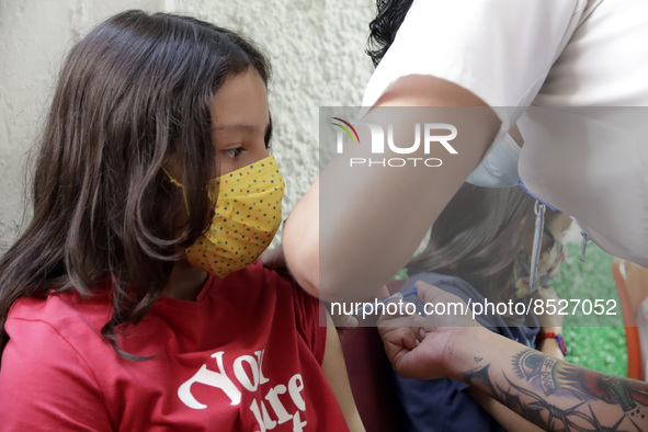  A child receives a Pfizer first dose at the  Portales Health Center during a health campaign to children under 9 years of age  at the start...