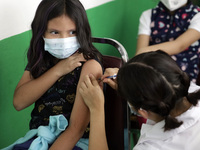  A child receives a Pfizer first dose at the  Portales Health Center during a health campaign to children under 9 years of age  at the start...