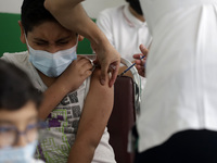  A child receives a Pfizer first dose at the  Portales Health Center during a health campaign to children under 9 years of age  at the start...