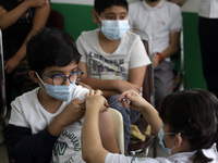  A child receives a Pfizer first dose at the  Portales Health Center during a health campaign to children under 9 years of age  at the start...