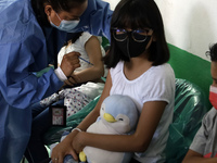  A child receives a Pfizer first dose at the  Portales Health Center during a health campaign to children under 9 years of age  at the start...