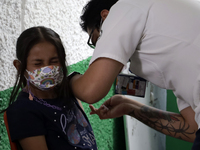  A child receives a Pfizer first dose at the  Portales Health Center during a health campaign to children under 9 years of age  at the start...