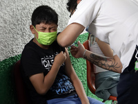  A child receives a Pfizer first dose at the  Portales Health Center during a health campaign to children under 9 years of age  at the start...