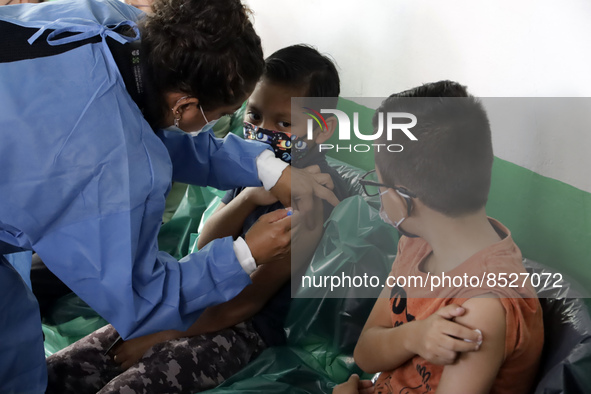  A child receives a Pfizer first dose at the  Portales Health Center during a health campaign to children under 9 years of age  at the start...