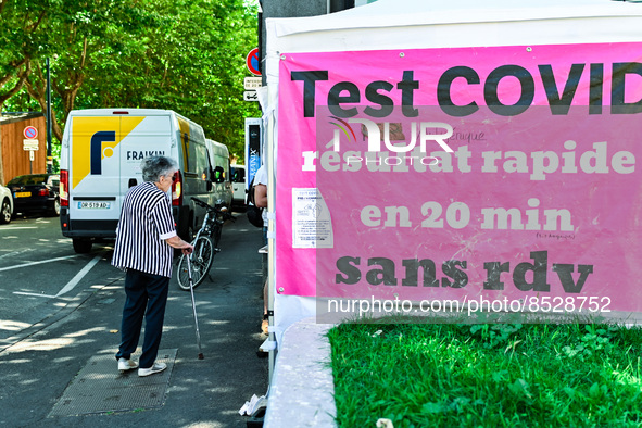 An elder woman walks by the tent. France sees a resurgence of Covid19 cases. Many people come to get tested in  Clermont-Ferrand, France, on...