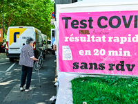 An elder woman walks by the tent. France sees a resurgence of Covid19 cases. Many people come to get tested in  Clermont-Ferrand, France, on...