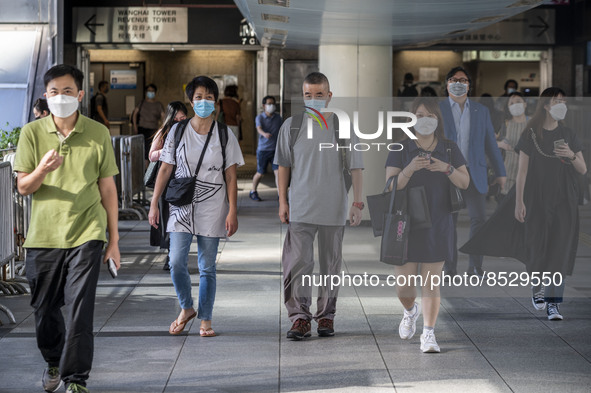 People wearing Face mask walking on a footbridge in Wan Chai District on July 12, 2022 in Hong Kong, China. The Hong Kong Government announc...