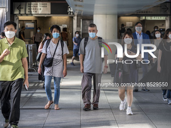 People wearing Face mask walking on a footbridge in Wan Chai District on July 12, 2022 in Hong Kong, China. The Hong Kong Government announc...