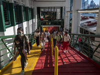 People wearing face masks walking up the pier after exiting the Star Ferry on July 12, 2022 in Hong Kong, China. The Hong Kong Government an...