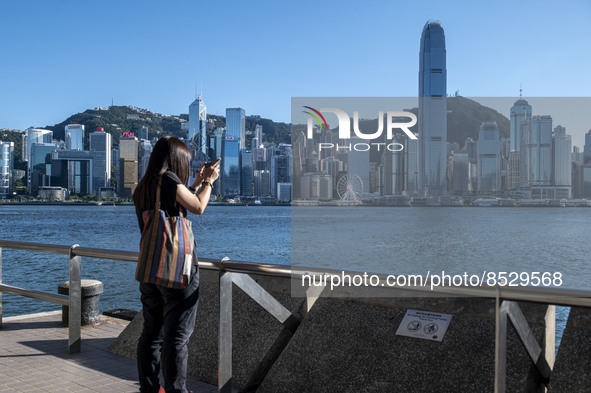 A women taking photos of the Hong Kong Skyline on July 12, 2022 in Hong Kong, China. The Hong Kong Government announce that it would extend...