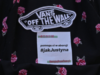 a sticker with words 'I will help you with an abortion #Like Justyna' seen on an activist t-shirt.
Polish activist, Justyna Wydrzynska is fa...