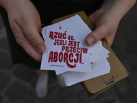 An activist holds stickers with words 'Drop him if he's against abortion'.
Polish activist, Justyna Wydrzynska is facing three years in pris...