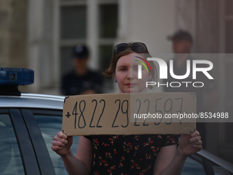 An activist holds a sign with a phone number of the national support line for Polish women.
Polish activist, Justyna Wydrzynska is facing th...