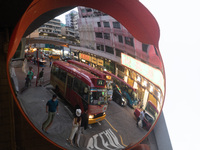 Hong Kong, China, 3 Jul 2022, A red minibus is seen parked in Mongkok in a mirror. (