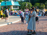 Hong Kong, China, 10 Jul 2022, Young ladies take selfies unmasked before the Hong Kong Disneyland castle. (