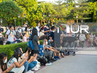 Hong Kong, China, 10 Jul 2022, People sit down in front of the Hong Kong Disneyland castle, waiting for a show to start. (