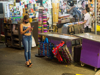 Hong Kong, China, 15 Jul 2022, A young lady checks her phone in Causeway Bay. (