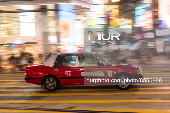 Hong Kong, China, 15 Jul 2022, A taxi rushes in this panned shot in Causeway Bay. 