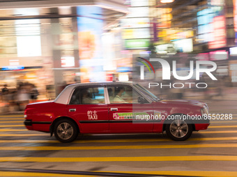 Hong Kong, China, 15 Jul 2022, A taxi rushes in this panned shot in Causeway Bay. (