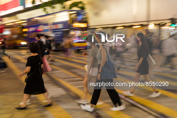 Hong Kong, China, 15 Jul 2022, People cross the street in Causeway Bay. 