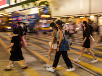 Hong Kong, China, 15 Jul 2022, People cross the street in Causeway Bay. (